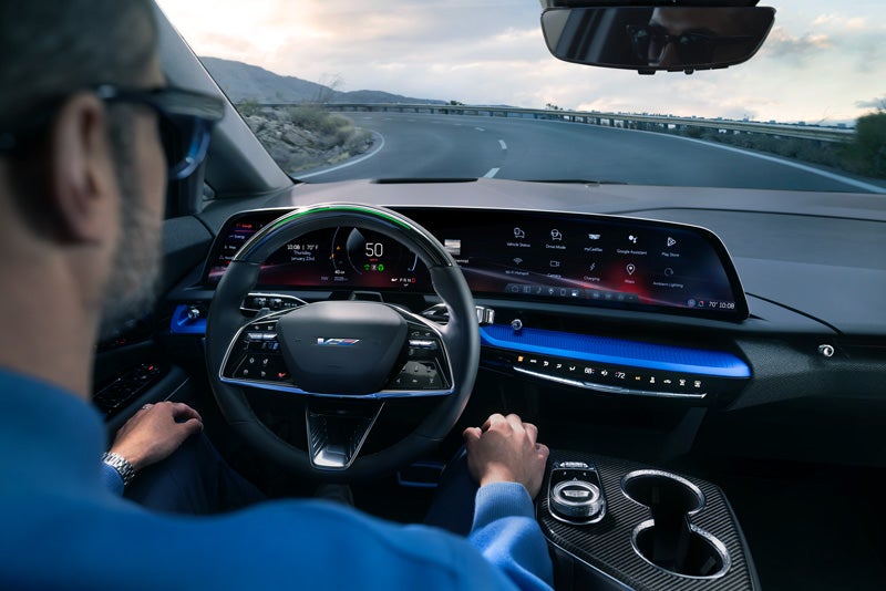 Front View of the 2026 OPTIQ-V Driving Through the Dusk Utilizing its Headlights | Bergstrom Cadillac of Oshkosh in Oshkosh WI